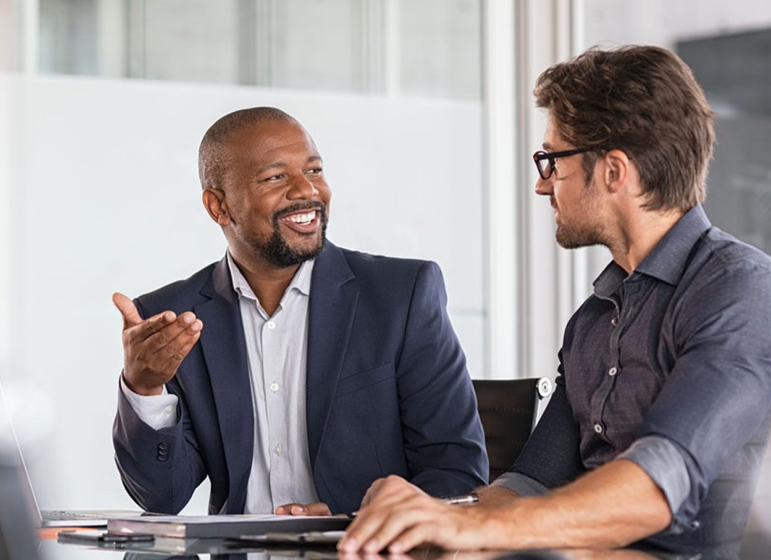 Our Business Partners - Two Businessmen Working Together on a Project in the Office