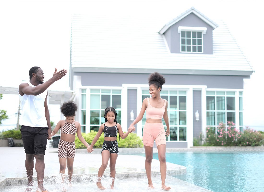Personal Insurance - A Young Family Having Fun and Relaxing by the Pool While on Vacation